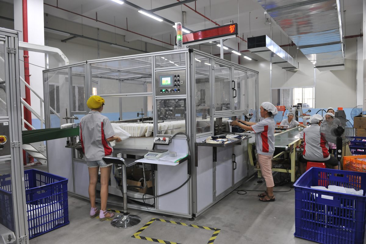 Experienced operator overseeing high-speed adult diaper production with in-line QC every 30 min